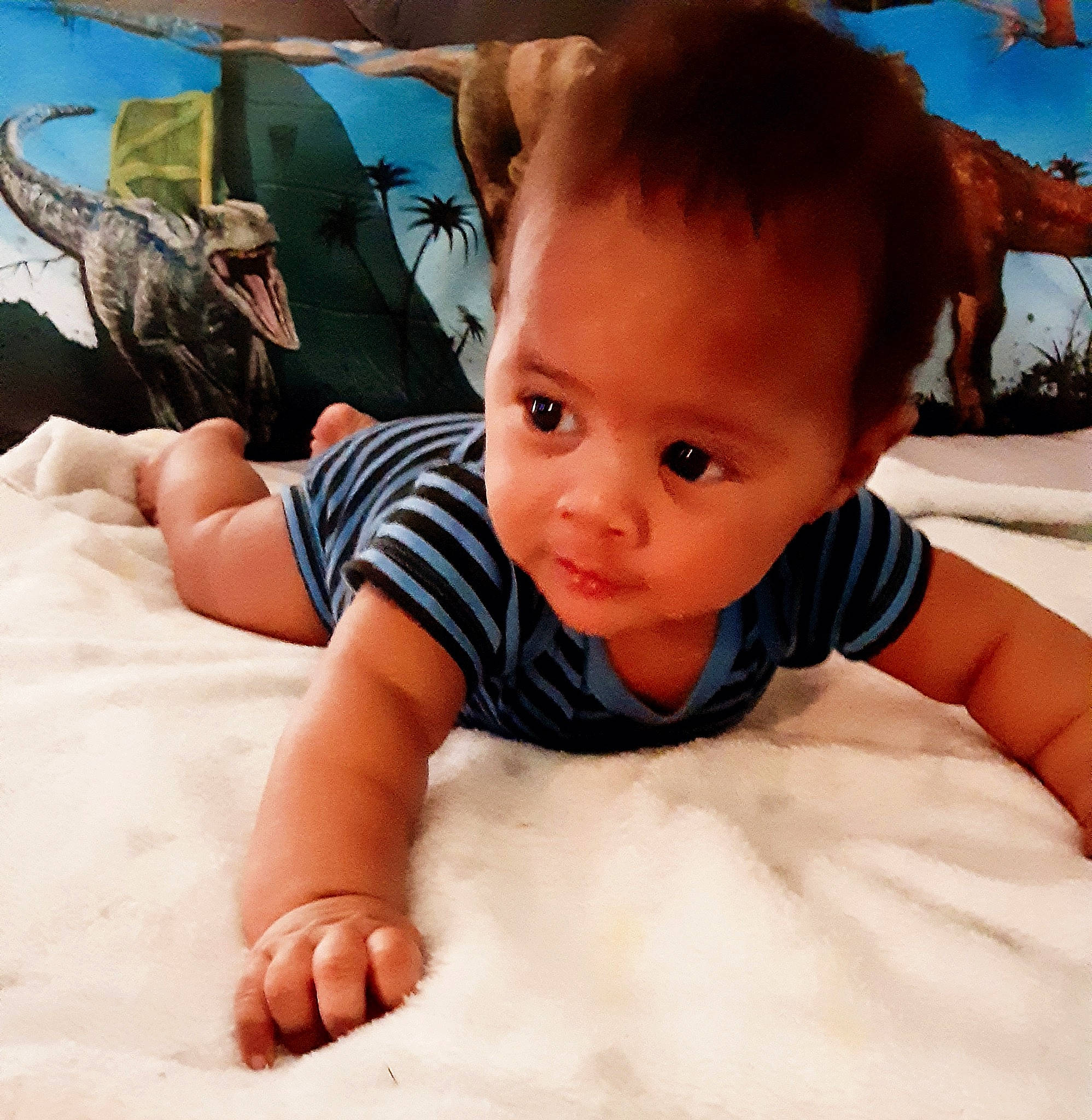 Jesiah is registered to the contest to win money with this photo: arm, baby, baby_toddler_clothing, comfort, cool, finger, flooring, fun, hairstyle, hand, happy, head, human_body, leg, linens, person, skin, sleeve, t_shirt, thumb