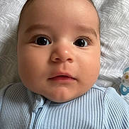 Zen is registered to the contest to win money with this photo: baby, close_up, face, infant, child, eyes, blanket, pacifier, clothing, ribbed_fabric, cute, portrait, lying_down, soft_light, indoor, skin, mouth, nose, head, young