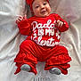 Emberly joined the competition — help win amazing prizes! baby, infant, red_clothing, headband, bow, smile, blanket, text, socks, cute, happy, portrait, indoors, soft_texture, child, cozy, valentine, warm, person, laying_down