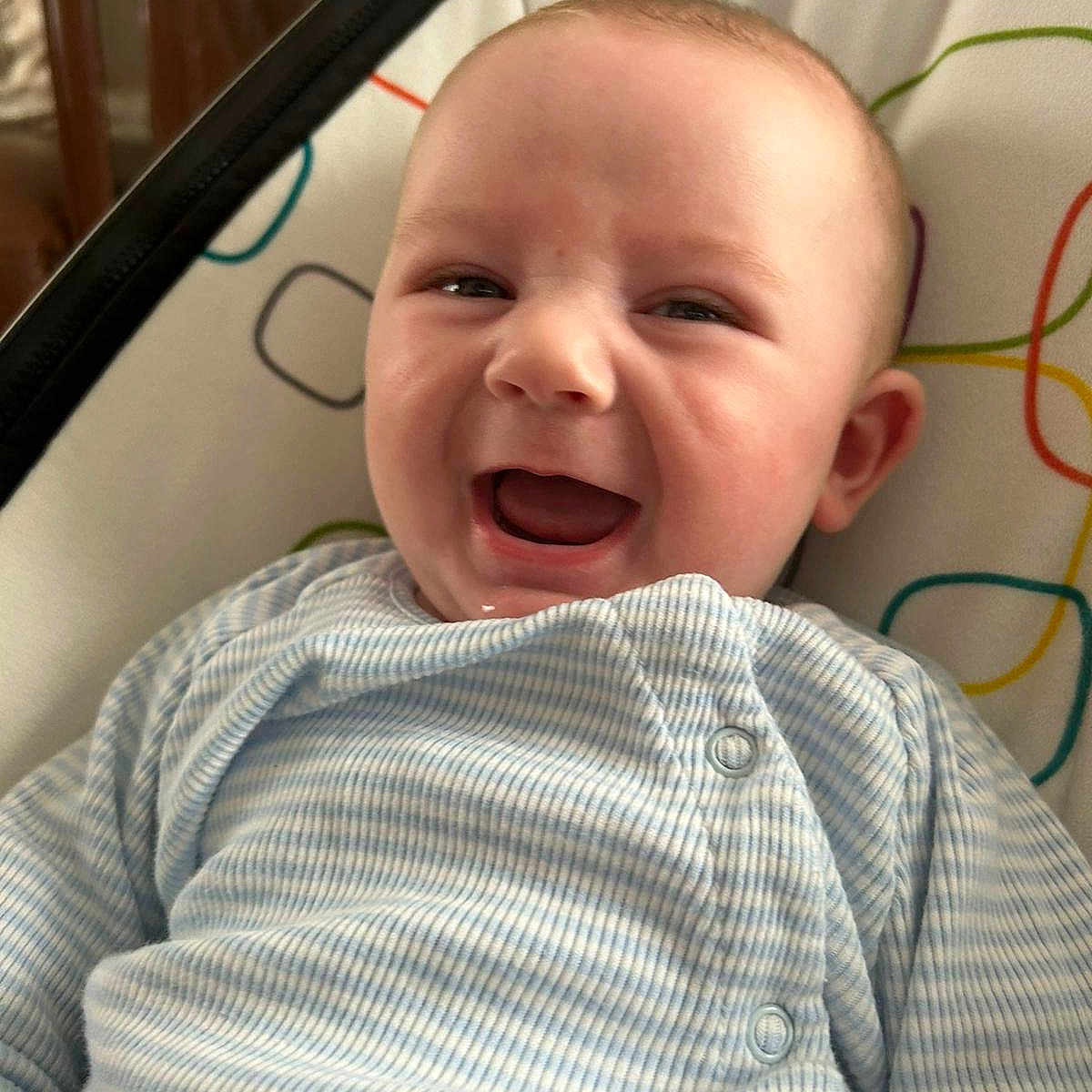 Ollie is registered to the contest to win money with this photo: baby, babylaughing, clothing, coat, face, happy, head, laughing, newborn, person, photography, portrait, smile