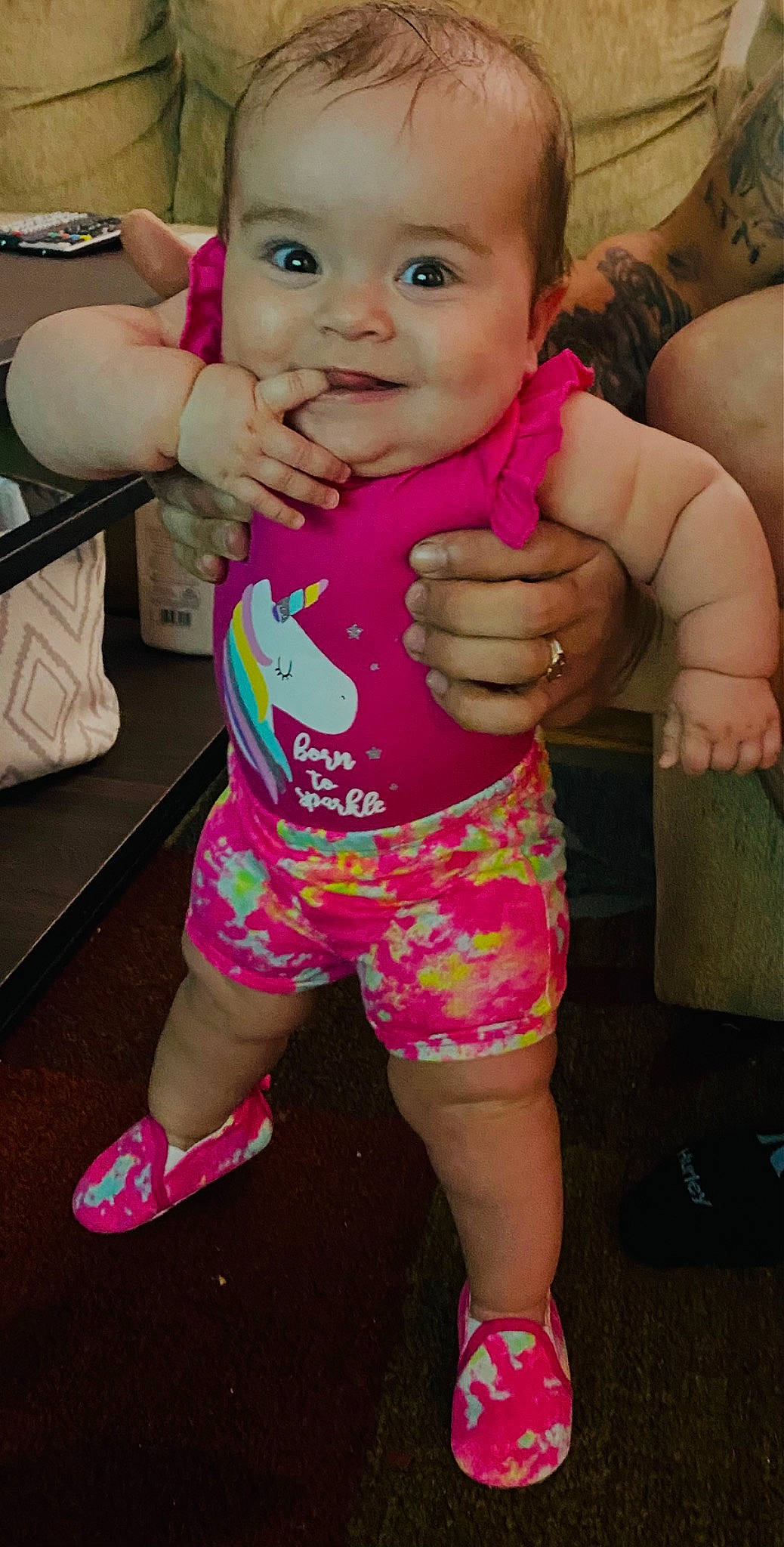 Mari is registered to the contest to win money with this photo: arm, baby, baby_toddler_clothing, cheek, finger, fun, gesture, hand, happy, joint, joy, mouth, nail, neck, person, pink, skin, sleeve, smile, thigh