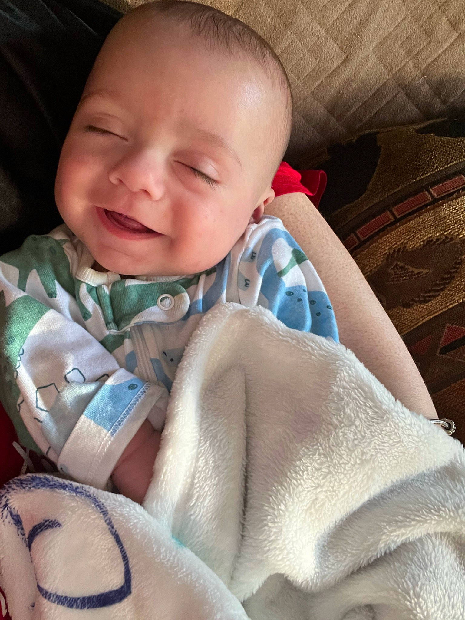 Jett is registered to the contest to win money with this photo: baby, baby_toddler_clothing, cheek, chin, comfort, eye, eyebrow, face, finger, happy, head, iris, joy, linens, mouth, nose, person, skin, sleeve, smile