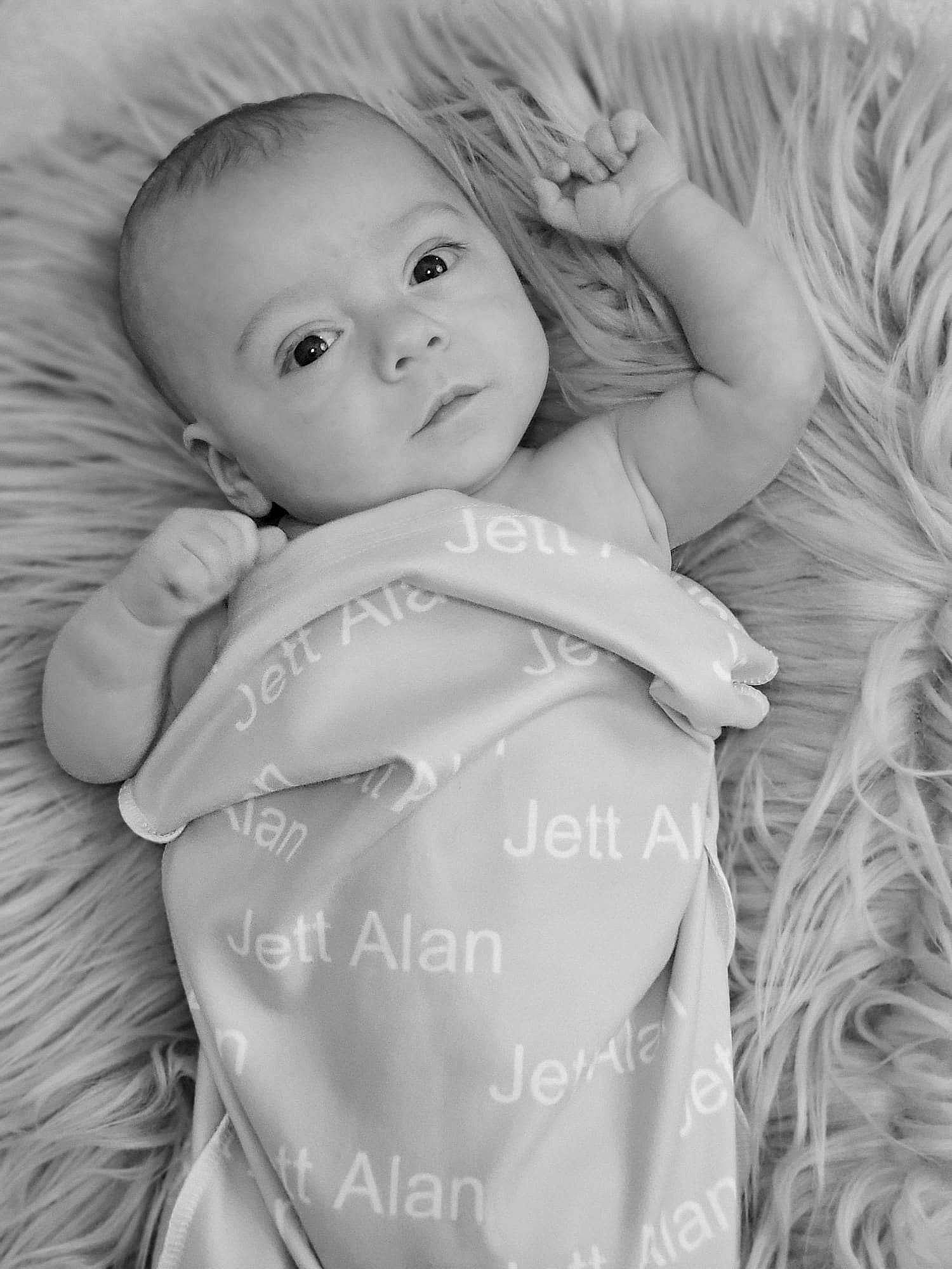 Jett is registered to the contest to win money with this photo: baby, baby_toddler_clothing, cheek, comfort, eye, face, finger, flash_photography, gesture, happy, head, iris, lip, monochrome_photography, people_in_nature, person, photograph, skin, sleeve, smile