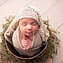 newborn, baby, sleeping, wrapped, hat, bucket, greenery, soft, cozy, peaceful, infant, cute, portrait, indoors, hands, headwear, blanket, wooden_floor, nature, resting