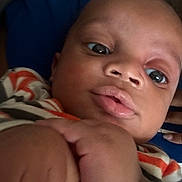 Mahari is registered to the contest to win money with this photo: baby, close_up, face, hand, infant, curious, plump_lips, striped_clothing, skin, child, person, portrait, indoors, cute, young, expression, human, fingertips, holding, casual