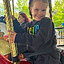 Phoenix joined the competition — help win amazing prizes! child, girl, smiling, pigtails, carousel, horse, golden_pole, black_hoodie, jeans, seatbelt, outdoor, trees, woman, red_hair, amusement_ride, daylight, happy, fun, park, portrait