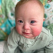 Jackson joined the competition — help win amazing prizes! baby, child, face, portrait, rosy_cheeks, blue_eyes, green_outfit, infant, cute, sitting, blanket, soft_focus, indoors, smile, close_up, person, young_child, head, skin, warm