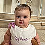 baby, child, indoor, cute, pigtails, white_top, purple_clothing, chubby_cheeks, face, person, expression, sitting, floor, wooden_floor, steps, arms, hand, looking_at_camera, casual_clothing, portrait