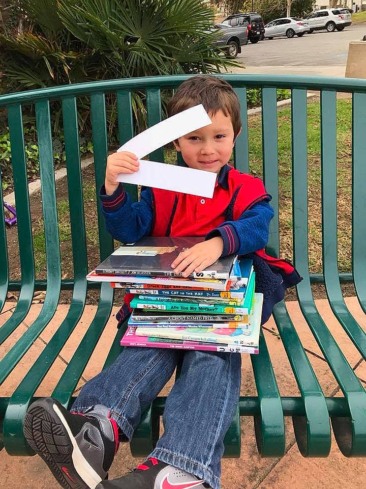 Kamden is registered to the contest to win money with this photo: child, joy, leisure, person, play, reading, sitting, toddler