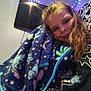 Kayleigh joined the competition — help win amazing prizes! child, blanket, cozy, selfie, smile, curly_hair, indoor, room, wall, string_lights, television, cow_print, pajamas, bed, plaid, purple, blue, casual, portrait, young