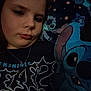bedroom, blanket, blue, cartoon, character, child, clothing, comfort, cozy, expression, face, indoor, jewelry, necklace, pillow, portrait, sleep, stitch, tired, young