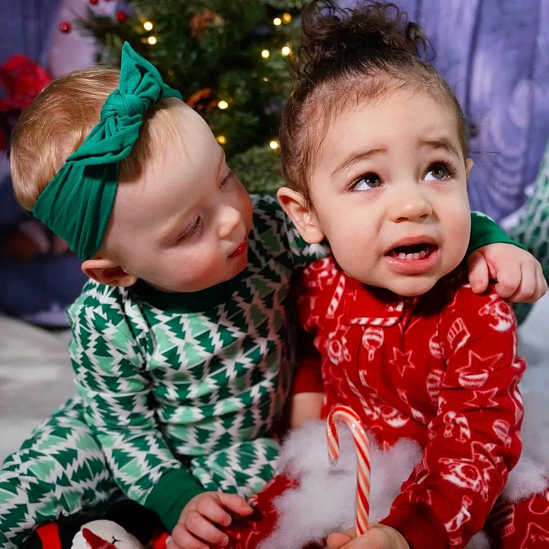 Alani joined the competition — help win amazing prizes! baby, baby_toddler_clothing, child, christmas_tree, eye, face, facial_expression, fun, happy, head, human_body, lap, people, person, photograph, red, skin, sleeve, smile, standing
