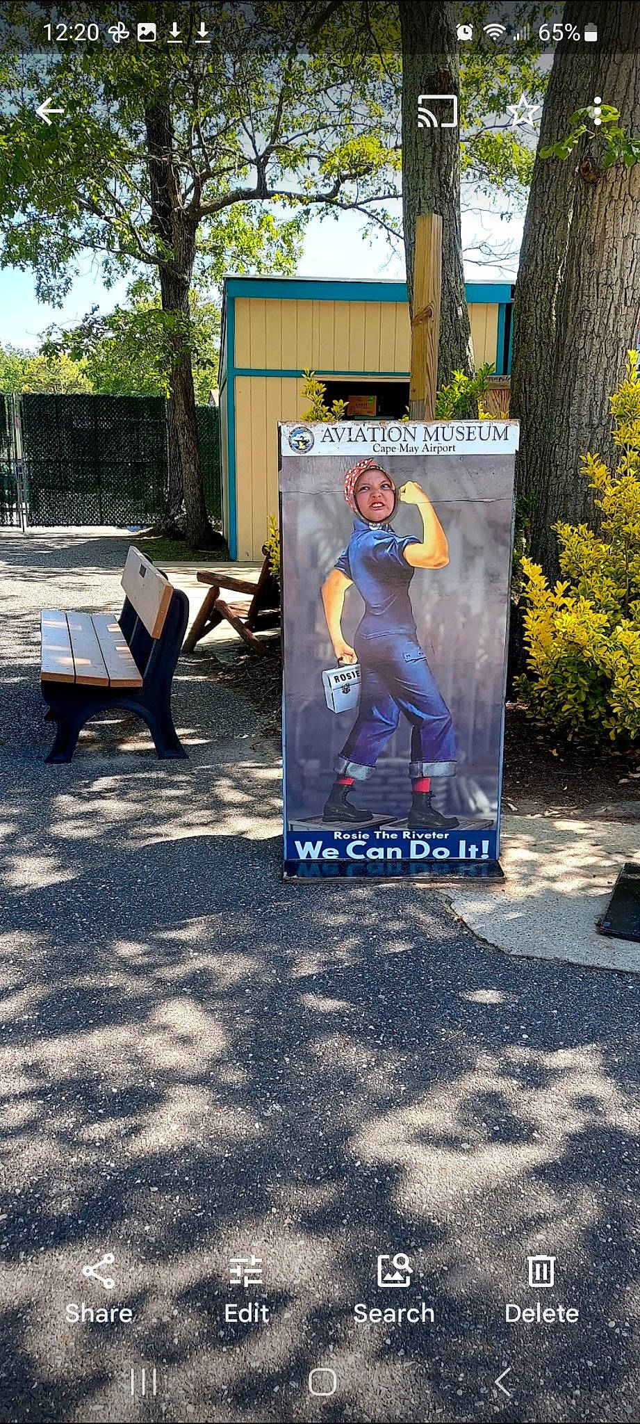 Sienna is registered to the contest to win money with this photo: advertising, anger, art, asphalt, banner, billboard, city, electric_blue, font, fun, grass, headwear, leisure, person, plant, recreation, road_surface, sidewalk, sign, signage