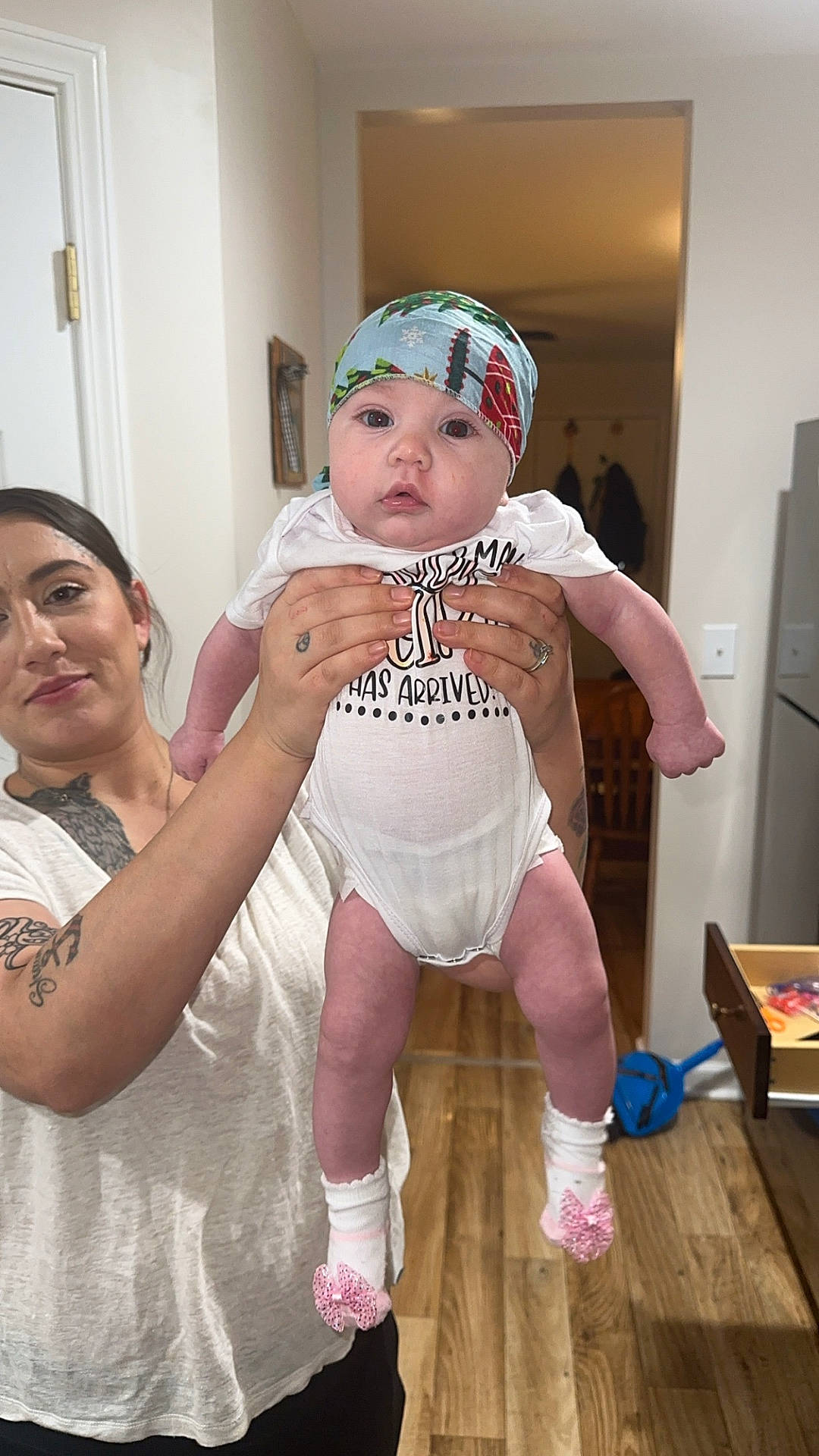 adult, baby, cap, clothing, face, female, hardwood, hat, head, hosiery, newborn, person, photography, portrait, skin, sock, t_shirt, tattoo, woman, wood