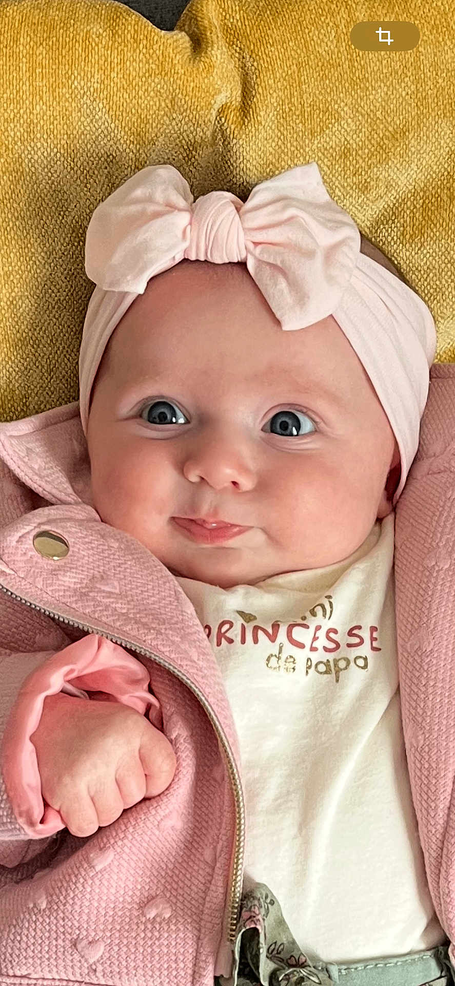 Elia participe au concours pour gagner de l'argent avec cette photo : baby, infant, pink_bow, pink_jacket, yellow_blanket, closeup, portrait, cute, child, headband, clothing, face, hand, skin, expression, smile, indoors, person, newborn, fashion