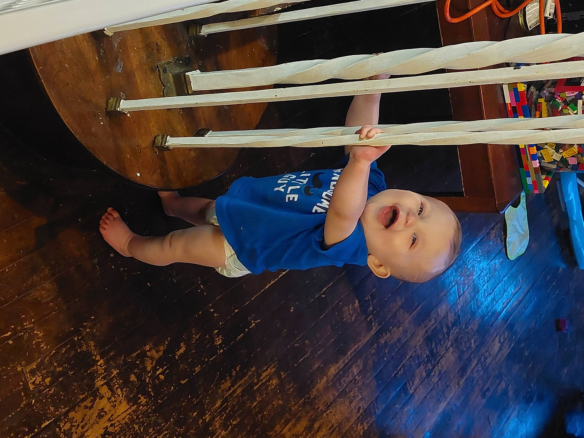 Franky is registered to the contest to win money with this photo: baby, baby_toddler_clothing, child, elbow, electric_blue, flooring, fun, happy, hardwood, human_leg, leg, leisure, person, smile, sportswear, t_shirt, thigh, toddler, varnish, wood