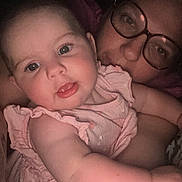 Ysaline participe au concours pour gagner de l'argent avec cette photo : adult, arm, baby, child, close_up, cute, expression, eyewear, face, glasses, holding, human, indoor, infant, person, pink_dress, portrait, skin, smiling, tattoo