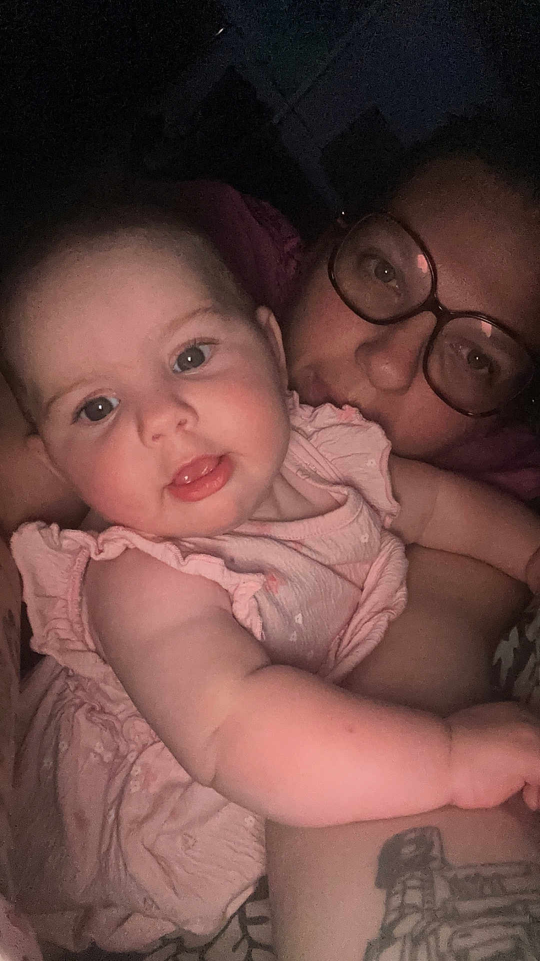 Ysaline participe au concours pour gagner de l'argent avec cette photo : adult, arm, baby, child, close_up, cute, expression, eyewear, face, glasses, holding, human, indoor, infant, person, pink_dress, portrait, skin, smiling, tattoo