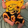 Ellanor is registered to the contest to win money with this photo: baby, blanket, child, clothing, cute, face, foot, hand, happy, indoors, infant, lying_down, mittens, patterned_pants, person, playful, smiling, soft_texture, sunflower, yellow_shirt