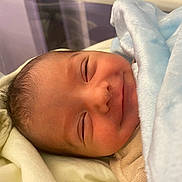 Milano participe au concours pour gagner de l'argent avec cette photo : newborn, baby, infant, smiling, sleeping, blanket, blue_blanket, face, closeup, cozy, soft, wrapped, cute, child, indoors, portrait, peaceful, young, human, skin