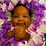 Kamouri joined the competition — help win amazing prizes! adorable, baby, bright_eyes, cheeks, closeup, cute, face, flower_lei, hands, happy, head, infant, lying_down, portrait, purple, skin, smile, soft_surface, white, young_child