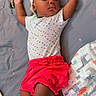 baby, sleeping, headband, polka_dot, shirt, red_shorts, bed, diapers, hairbrush, comb, toothbrush, infant, peaceful, resting, indoors, child, cute, relaxing, soft_lighting, toddler