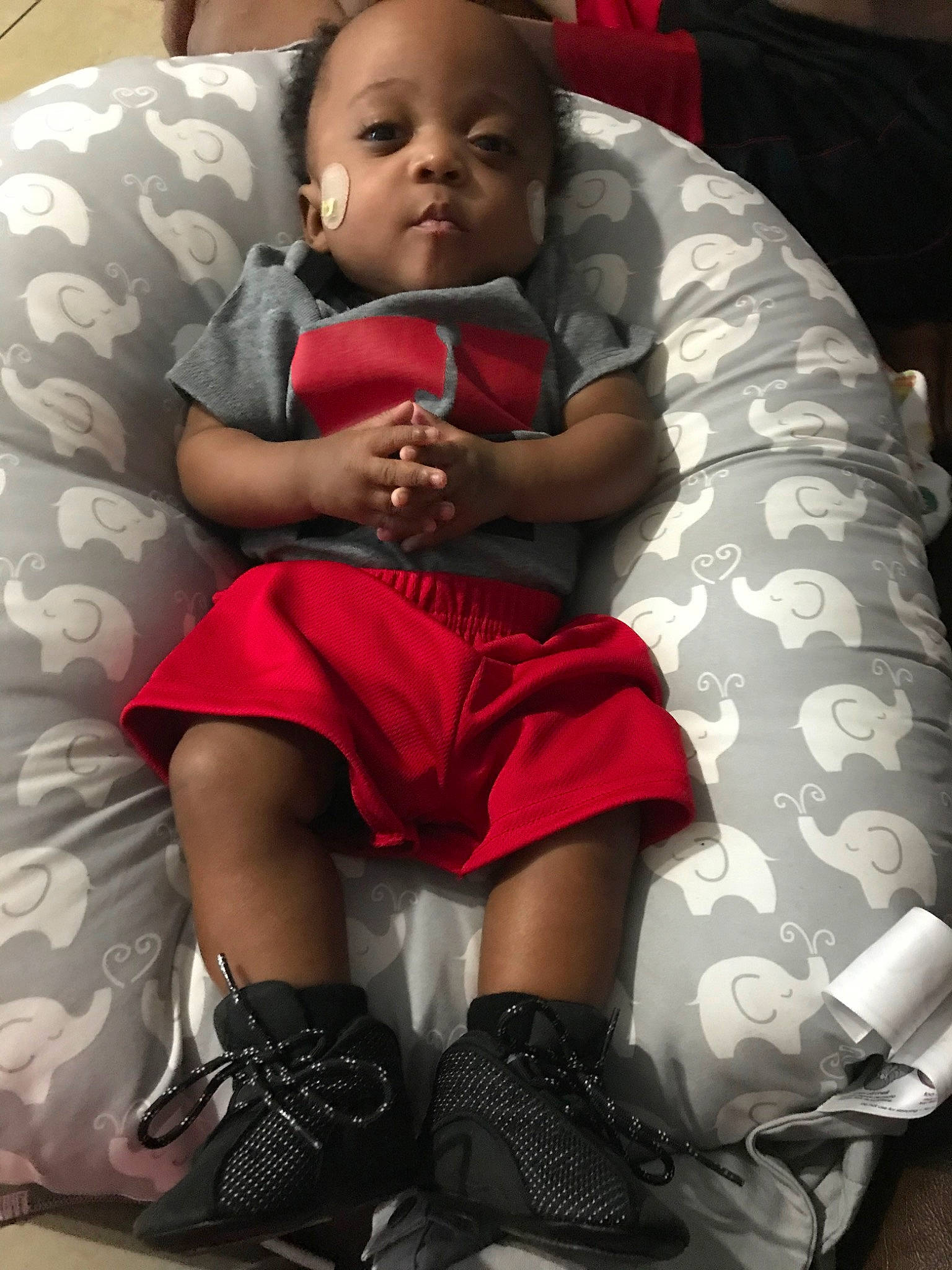 Josh is registered to the contest to win money with this photo: arm, baby, cheek, child, comfort, human_leg, knee, lap, leg, person, shoe, sitting, thigh, toddler