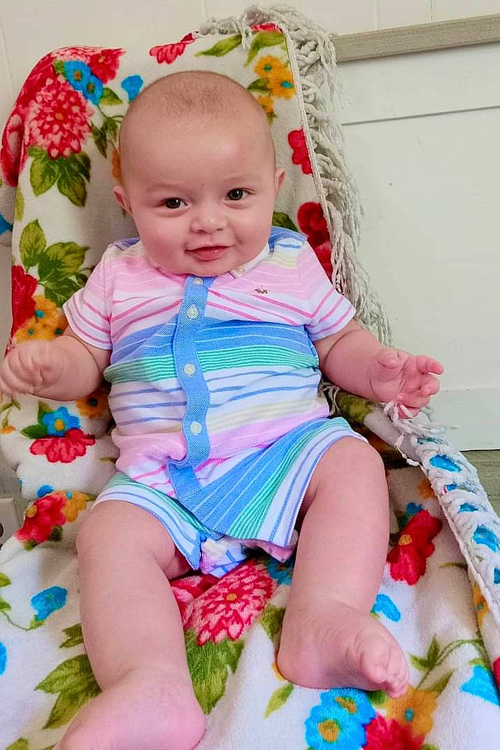 Corbin joined the competition — help win amazing prizes! baby, baby_toddler_clothing, cheek, child, dress, eye, face, facial_expression, finger, hairstyle, happy, head, joy, pattern, person, pink, product, skin, sleeve, smile