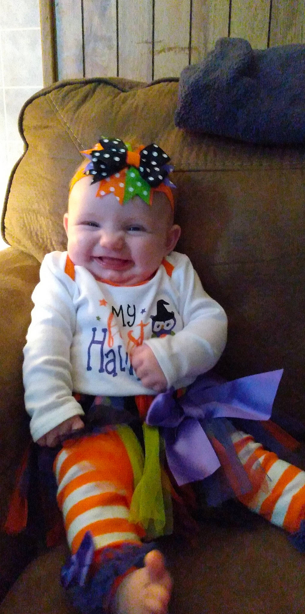 Heidi joined the competition — help win amazing prizes! baby, baby_laughing, baby_toddler_clothing, blue, child, comfort, cool, couch, face, facial_expression, fun, happy, head, headgear, headwear, joy, knit_cap, orange, person, personal_protective_equipment
