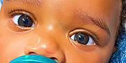 Amor joined the competition — help win amazing prizes! baby, pacifier, close_up, face, eyes, curly_hair, skin, blanket, infant, child, cute, portrait, resting, comfort, teal, blue, sleepwear, nose, mouth, expression