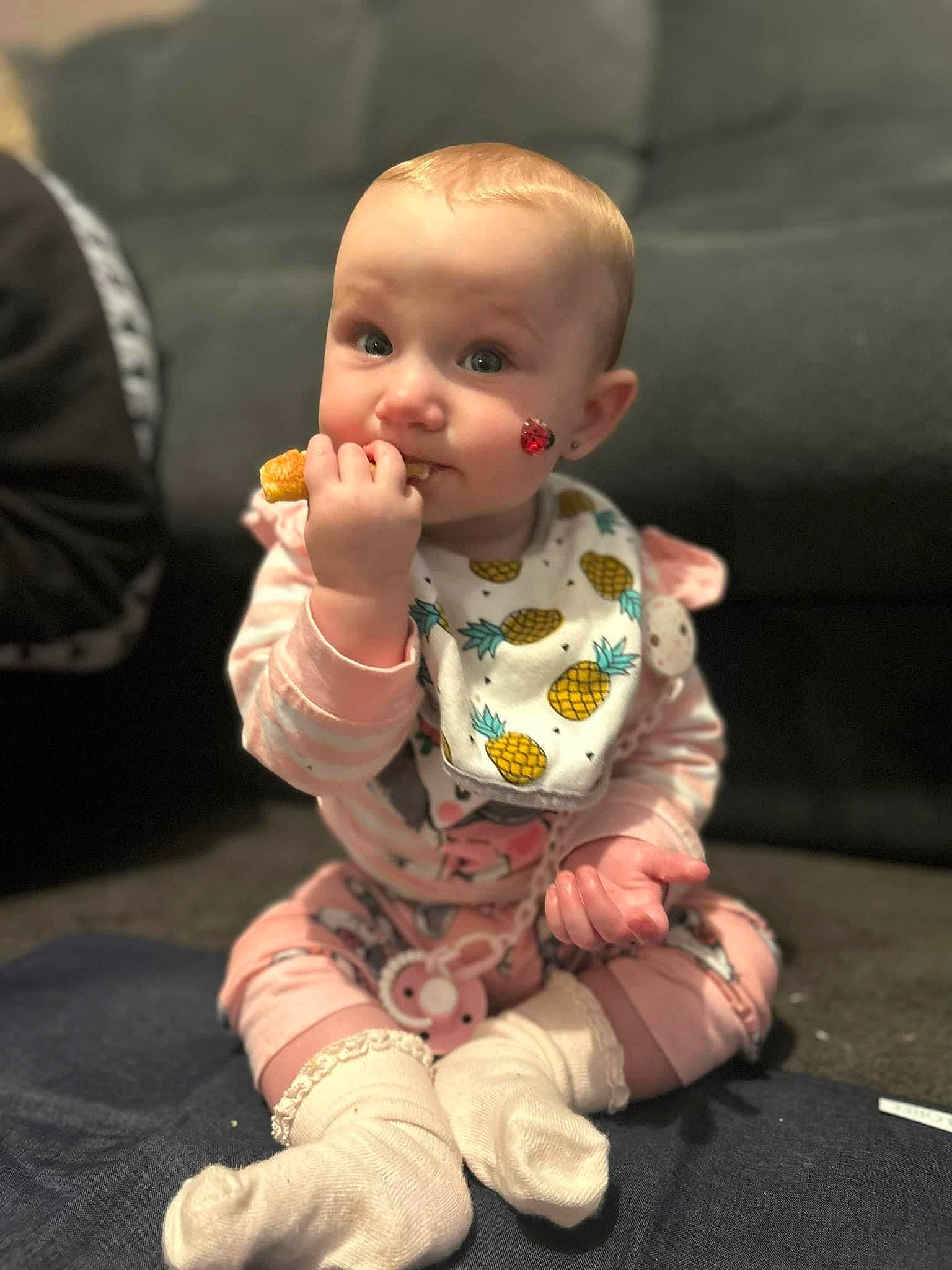 Harleigh is registered to the contest to win money with this photo: baby, baby_toddler_clothing, cheek, child, eye, finger, flooring, foot, fun, gesture, hand, happy, head, human_body, nose, person, sitting, skin, thumb, toddler