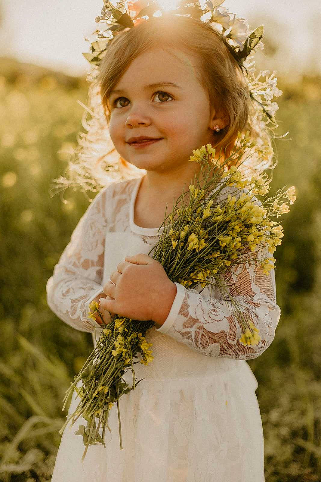 Elaina joined the competition — help win amazing prizes! bridal_clothing, dress, facial_expression, flash_photography, flower, grass, hair, hairstyle, happy, head, iris, joy, people_in_nature, person, petal, plant, skin, smile, standing, sunlight