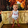 Kohen-Lee joined the competition — help win amazing prizes! toddler, child, standing, white_romper, red_sandals, wooden_bench, autumn, orange_leaves, fall, outdoor, portrait, cute, young_child, person, nature, seasonal, warm_colors, background_blur, baby, innocence