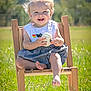 Kohen-Lee joined the competition — help win amazing prizes! toddler, child, smiling, outdoor, sunlight, wooden_chair, grass, toy, white_pumpkin, happy, portrait, sitting, nature, daylight, cute, baby, playful, clothing, barefoot, seasonal