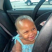 Elani joined the competition — help win amazing prizes! baby, child, car, car_seat, steering_wheel, blue_clothing, smiling, happy, indoors, window, vehicle, seatbelt, face, cute, young_child, transportation, daylight, skin, person, expression