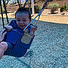 child, toddler, swing, playground, outdoor, smiling, blue_swing, trees, sunny, daytime, grass, residential_area, person, happy, holding, play, recreation, casual_clothing, fun, park