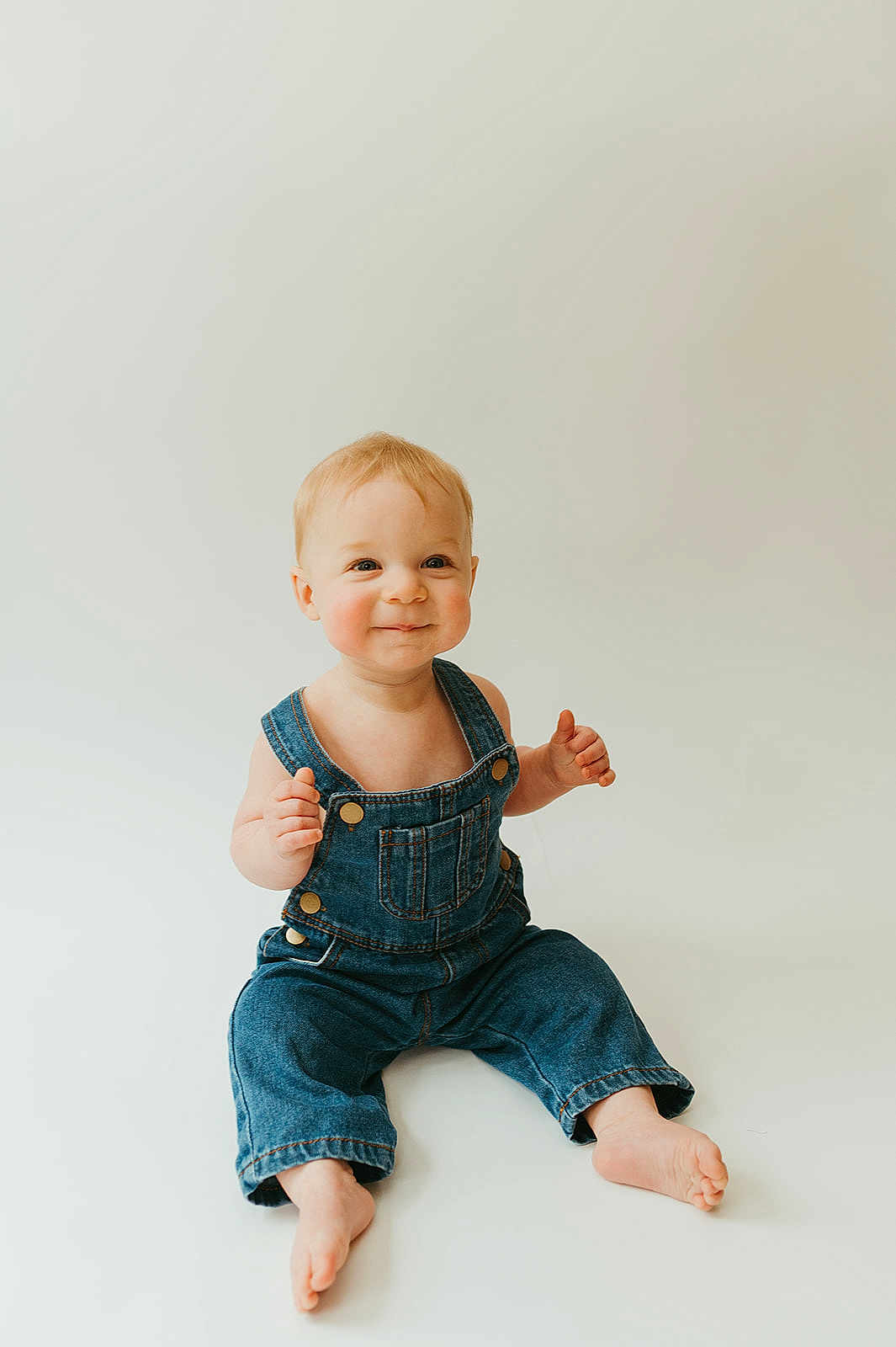 Jack joined the competition — help win amazing prizes! baby, child, denim_overalls, smiling, sitting, barefoot, light_background, cute, happy, portrait, infant, young_child, studio_photo, casual_clothing, one_person, small_child, indoors, face, skin, blond_hair