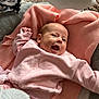 baby, pink_clothing, blanket, smiling, infant, toy, plush_cloud, elephant_toy, soft_texture, happy, child, cute, indoor, cozy, portrait, toddler, baby_girl, cushion, laying_down, warm
