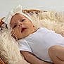 Mabel is registered to the contest to win money with this photo: baby, infant, headband, bow, basket, white_clothing, fluffy_blanket, soft_texture, cute, portrait, lying_down, newborn, skin, expression, indoors, comfortable, closeup, child, adorable, peaceful