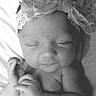 Alaina joined the competition — help win amazing prizes! black_and_white, cheek, child, close_up, eye, face, forehead, girl, hair_accessory, hand, head, infant, lip, monochrome, monochrome_photography, nose, person, photograph, photography, skin