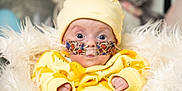 Jude joined the competition — help win amazing prizes! baby, infant, yellow_clothing, hat, nasal_tube, oxygen_tube, medical_tape, fluffy_blanket, blue_eyes, close_up, indoors, cute, newborn, person, face, expression, hospital, healthcare, child, portrait