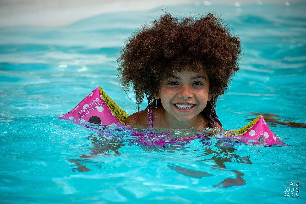 Inaya participe au concours pour gagner de l'argent avec cette photo : aqua, azure, bathing, fun, hair, hairstyle, happy, head, joy, leisure, magenta, people_in_nature, person, personal_protective_equipment, recreation, smile, summer, swimming_pool, swimwear, toddler