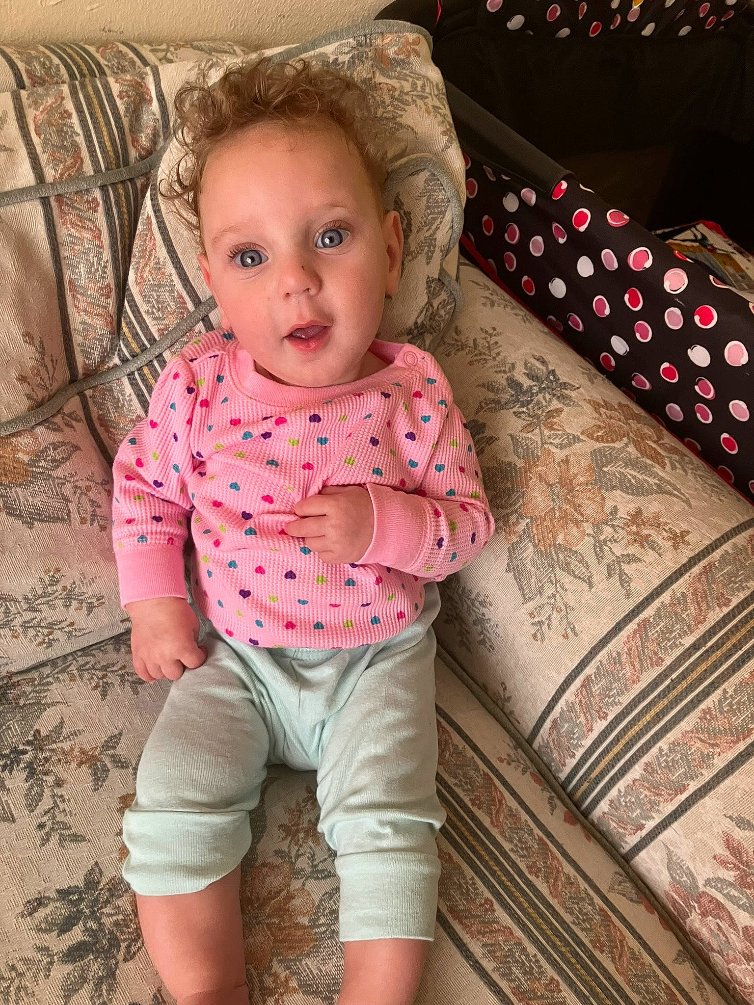 Neveah joined the competition — help win amazing prizes! baby, baby_toddler_clothing, cheek, child, eye, fashion_accessory, human_leg, magenta, neck, pattern, person, pink, product, sitting, skin, sleeve, surprise, t_shirt, thigh, toddler
