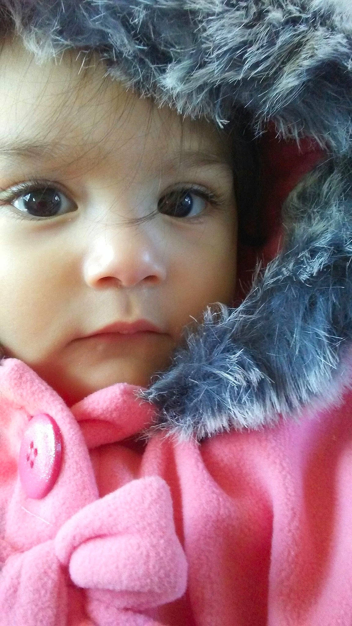 Isabela is registered to the contest to win money with this photo: baby, cheek, chin, eyebrow, eyelash, fur_clothing, gesture, hand, happy, headgear, iris, lip, mouth, nail, nose, organ, person, skin, textile, toddler