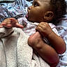 Loyalty joined the competition — help win amazing prizes! baby, infant, child, pacifier, blanket, floral_bedding, lying_down, indoor, portrait, profile, curly_hair, brown_skin, pink_clothing, cozy, soft_blanket, reaching, barefoot, relaxed, bed, close_up