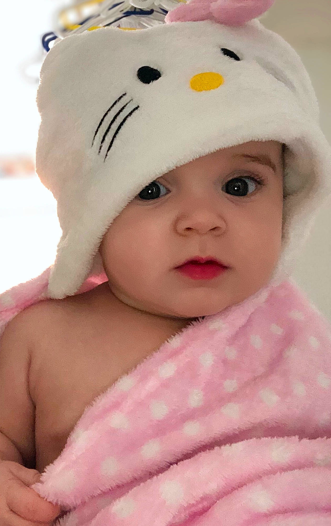 Malia is registered to the contest to win money with this photo: baby, baby_toddler_clothing, baseball_cap, cap, cheek, child, costume_hat, eyelash, fashion_accessory, hair_accessory, happy, hat, headgear, headwear, knit_cap, person, pink, skin, sleeve, sun_hat