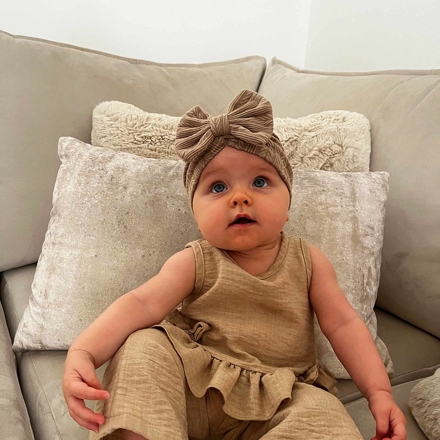 Novella joined the competition — help win amazing prizes! baby, beige, bow, child, clothing, comfortable, couch, curious, cute, headband, home, indoor, infant, person, pillows, plush, portrait, sitting, soft, young