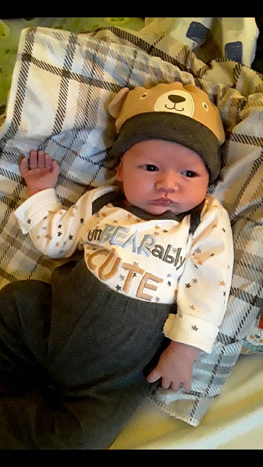 Jackson is registered to the contest to win money with this photo: baby, baby_carriage, baby_products, baby_toddler_clothing, baseball_cap, cap, cheek, child, comfort, fun, grass, happy, hat, headwear, pattern, person, sitting, sleeve, sun_hat, t_shirt