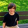 child, boy, bench, grass, greenery, outdoor, smiling, casual_clothing, shorts, tshirt, daylight, park, nature, happy, portrait, person, sitting, youth, hair, face