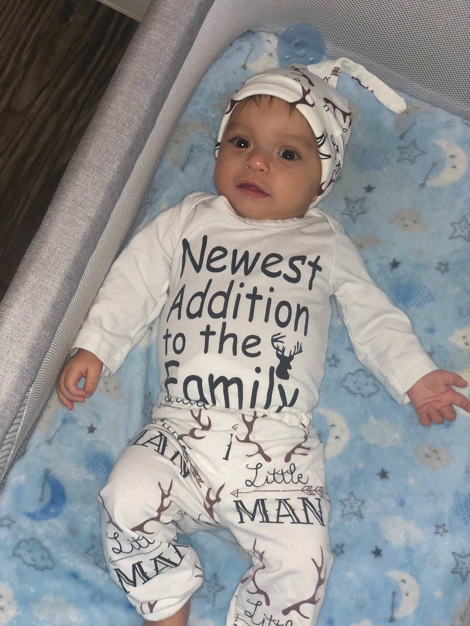 Bradley is registered to the contest to win money with this photo: baby, baby_products, baby_safety, baby_sleeping, baby_toddler_clothing, cap, comfort, cool, face, happy, head, headwear, linens, outerwear, pattern, person, sleeve, smile, sportswear, t_shirt